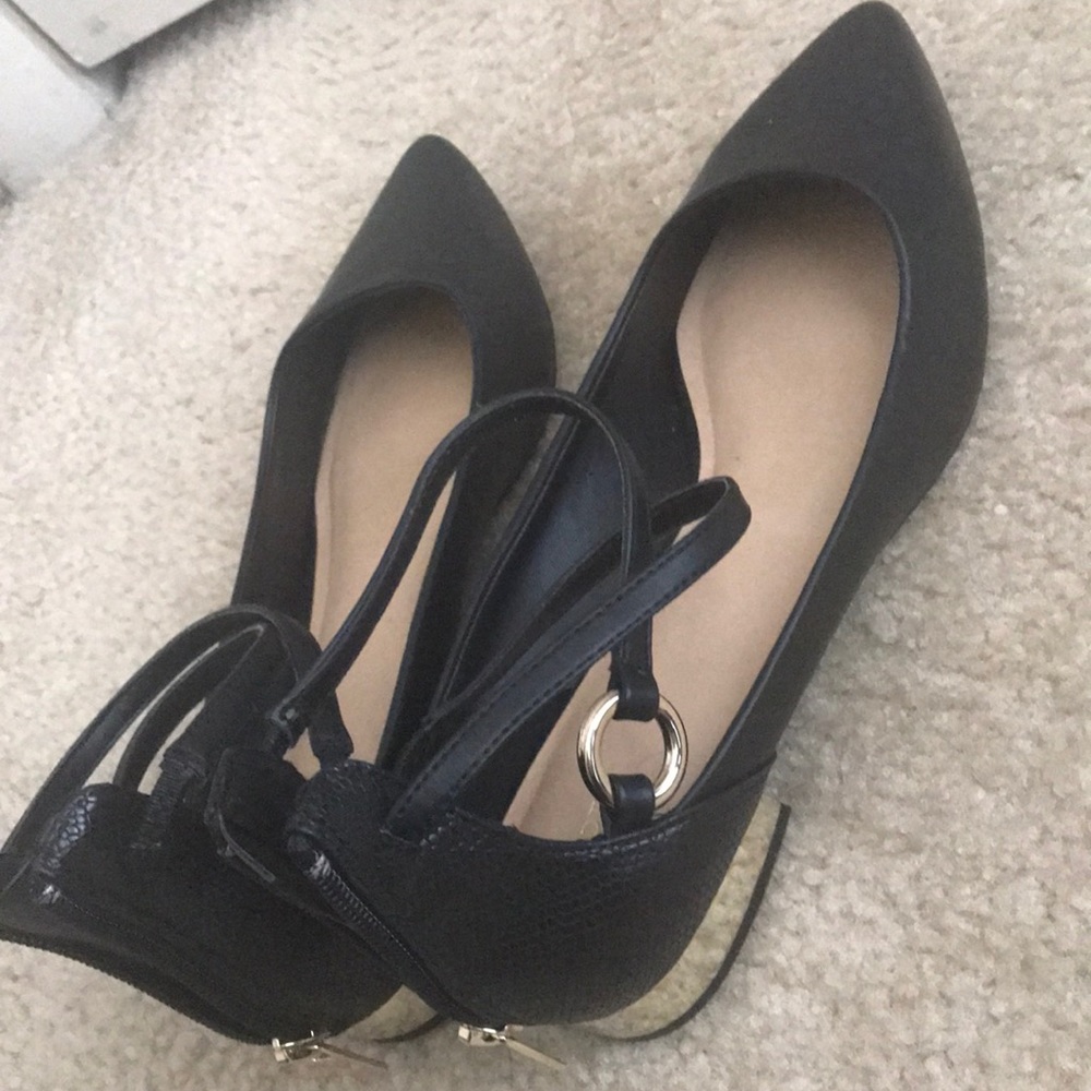 Black leather flats with gold zipper and detail